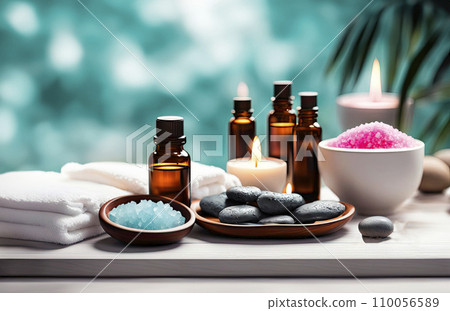 Beauty treatment items for spa procedures on white wooden table. massage stones, essential oils, sea salt, candles. 110056589