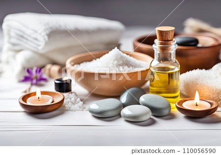 Beauty treatment items for spa procedures on white wooden table. massage stones, essential oils, sea salt, candles. 110056590