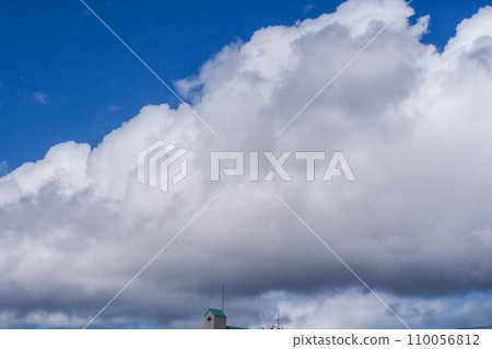 Blue sky, low clouds and a small blue roofed house Blue sky, low clouds and a small blue roofed house 110056812