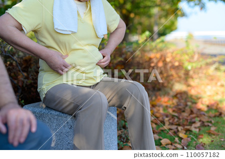 Senior female couple concerned about belly fat, bench break, walking, diet, exercise, healthy habits, walk 110057182
