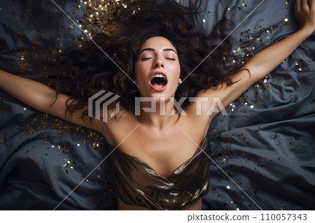 Young european woman having orgasm. Woman with open mouth and closed eyes enjoying sex lying among flying glitter and sparkles as a symbol of orgasm. Sexual experience, masturbation, cunnilingus. Young european woman having orgasm. Woman with open mouth and closed eyes enjoying sex lying among flying glitter and sparkles as a symbol of orgasm. Sexual experience, masturbation, cunnilingus. 110057343