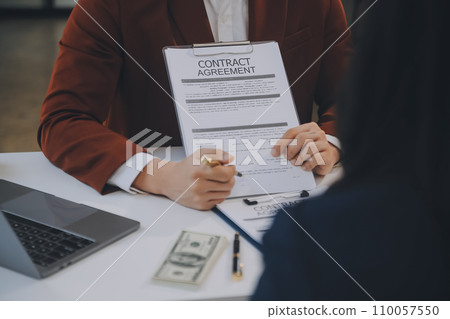 Lawyer, legal advisor, businessman brainstorming information on agreement details Business contracts in legal processing books for accuracy in contract documents. joint financial investment. 110057550