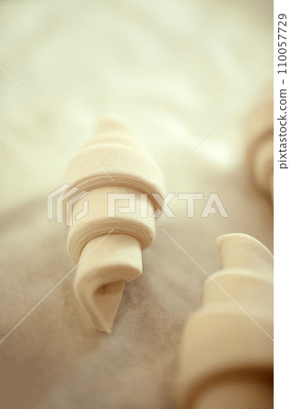 Close-up shot of croissant of puff pastry from traditional French recipe sitting on table in bakery. Concept of cuisine, food. 110057729