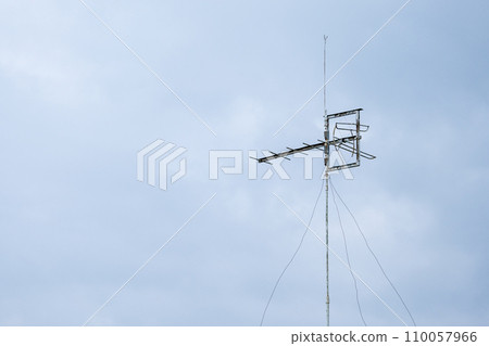 An old television antenna against blue sky. An old television antenna against blue sky. 110057966