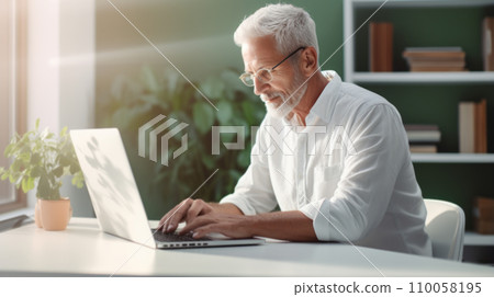 Senior person at home using laptop computer 110058195