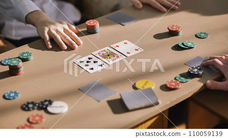 Young guys playing poker at a table. Young guys playing poker at a table. 110059139