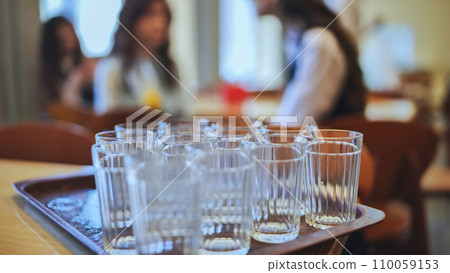Glass tumblers in the school cafeteria. Glass tumblers in the school cafeteria. 110059153