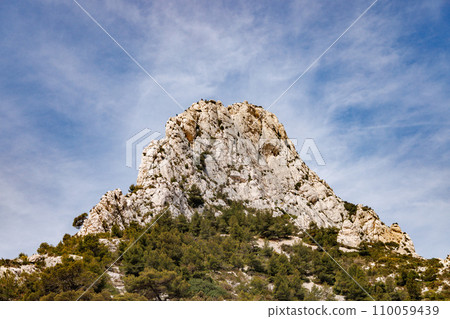 Tall symmetrical rock reaching into the sky. Tall symmetrical rock reaching into the sky. 110059439