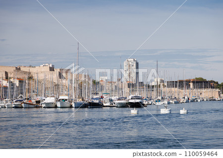 Sailing yachts are docked in the marina of Marseille. 110059464