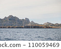 Rocky island with a high cliff, view from the sea. 110059469