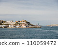 Exiting the port of Marseille into the sea, view of the green lighthouse. 110059472