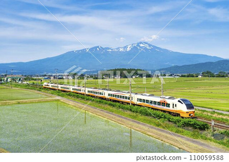 Limited express Inaho running on Mt. Chokai and Uetsu Line in early summer, Sakata City, Yamagata Prefecture 110059588