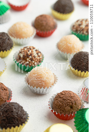 Typical Brazilian sweet brigadeiro. Assorted flavors of candies on a white table 110059711