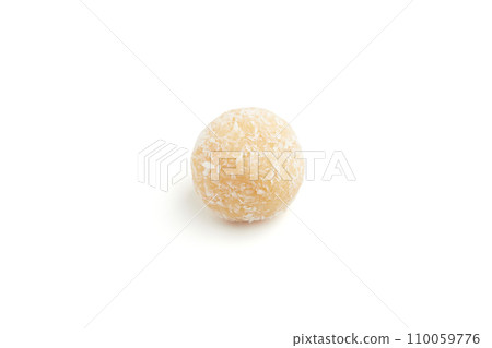 Typical Brazilian sweet brigadeiro. One coconut candy on a white background 110059776