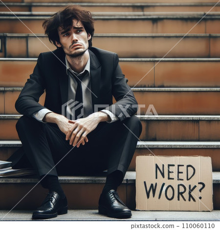 Man in suit sitting at stairs with sign. Unemployed man looking for job 110060110