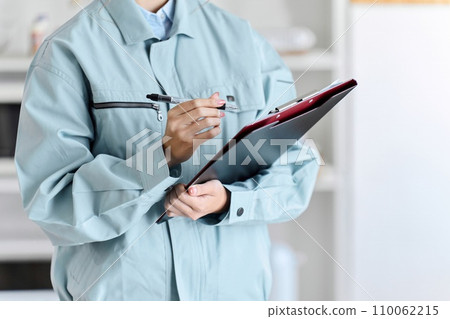 A professional woman comes to your home wearing work clothes to conduct an assessment. A professional woman comes to your home wearing work clothes to conduct an assessment. 110062215