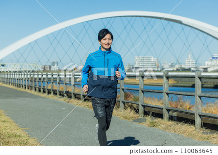 A man running on the riverbed A man running on the riverbed 110063645