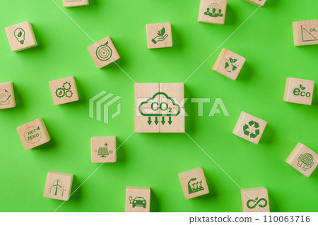 Carbon neutral concept. CO2 emissions reduction, Environment icons decrease CO2 on round wooden on green background. reduce carbon footprint, Net Zero, Sustainable energy, Globe climate change risk, 110063716