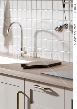 A bright beige-toned kitchen interior with sunlight coming through the window. A bright beige-toned kitchen interior with sunlight coming through the window. 110064861