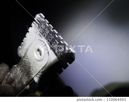 Checking film thickness with a wet gauge after painting during bridge repainting work 110064893