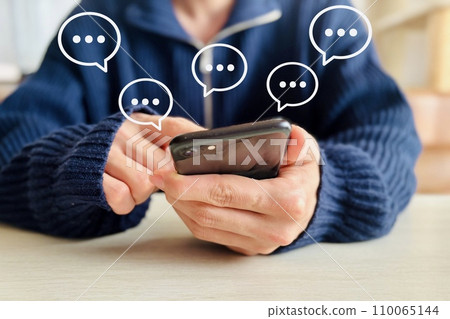 A man sending a message on a smartphone 110065144