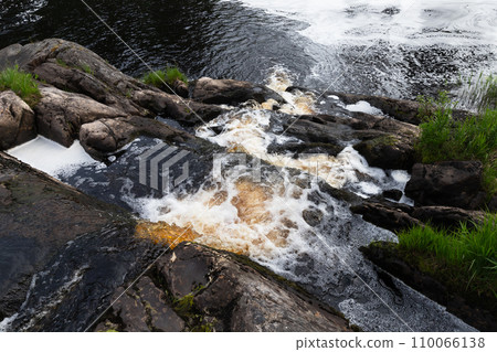 Fast stream water going over rocks in a forest. Waterfalls of Ruskeala Fast stream water going over rocks in a forest. Waterfalls of Ruskeala 110066138
