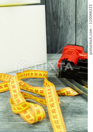 concept of furniture production and repair. Stapler and staples, working tool concept of furniture production and repair. Stapler and staples, working tool 110066233