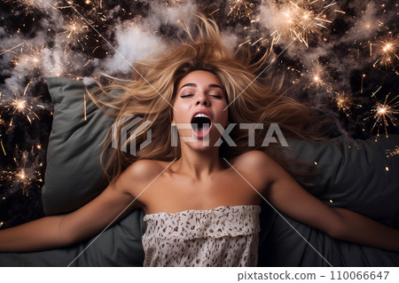 Young European woman having orgasm. Beautiful woman with open mouth and closed eyes enjoying sex lying among fireworks. Sparklers as a symbol of orgasm. Sexual experience, masturbation, cunnilingus. 110066647