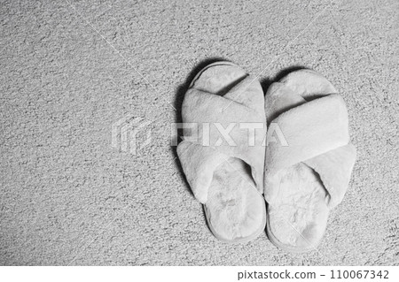 Modern Stylish Fluffy Grey House Slippers On Carpet, Top View, Space For Text. 110067342