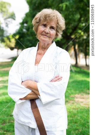 Old lady in white kimono outdoors Old lady in white kimono outdoors 110068945