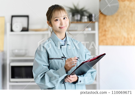 A professional woman comes to your home wearing work clothes to conduct an assessment. A professional woman comes to your home wearing work clothes to conduct an assessment. 110069671