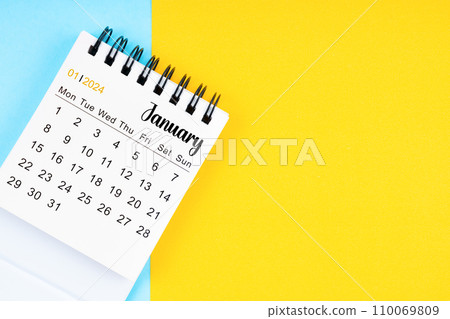 January 2024, Monthly desk calendar for 2024 year on yellow and blue background. 110069809