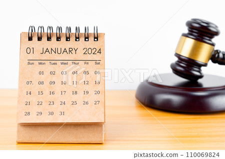 Desk calendar for January 2024 and judge's gavel. Desk calendar for January 2024 and judge's gavel. 110069824