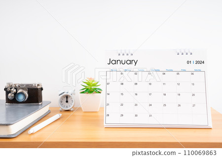 Desktop Calendar for January 2024 year and vintage camera with diary for Planner to plan timetable. 110069863