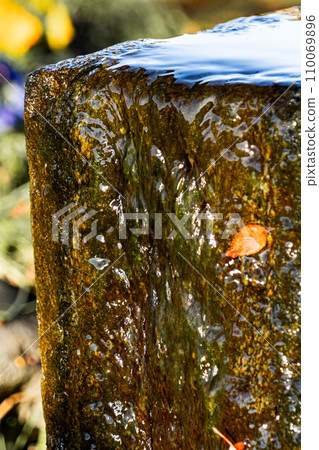 Clear water gushing out from a well in the park 110069896