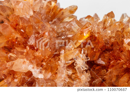 Macro of mineral stone Creedite on microcline on white background 110070687