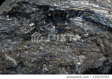 Macro of a stone Stibnite mineral on a black background 110070763