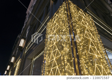 Illuminated night sidewalk show window 110071587