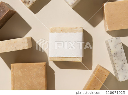 Beige and brown soap bars on light beige close up, hard shadows, packaging mockup Beige and brown soap bars on light beige close up, hard shadows, packaging mockup 110071925