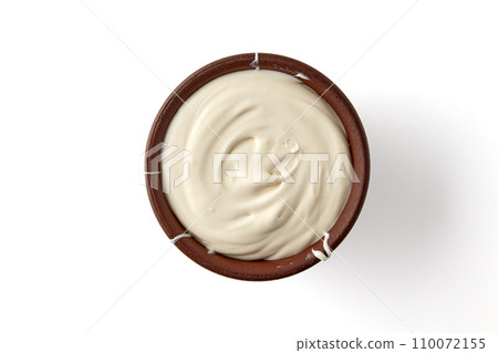 Brown clay bowl with yogurt isolated on white background. Top view with copy space 110072155