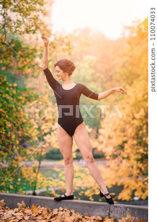 Beautiful female, ballerina, athlete in black bodysuit training in the park Beautiful female, ballerina, athlete in black bodysuit training in the park 110074033