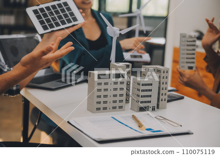 Electrical engineer with businessman discussing new project installation solar cell panel on the roof of building. Alternative energy concept. 110075119