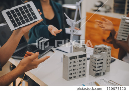 Electrical engineer with businessman discussing new project installation solar cell panel on the roof of building. Alternative energy concept. 110075120