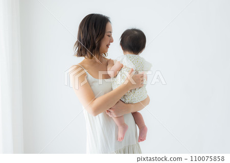 Woman holding a baby Woman holding a baby 110075858