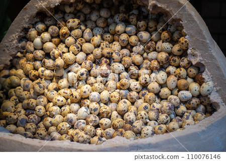 Quail eggs placed in basket on wooden table, Wuchang, China. 110076146