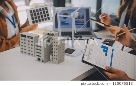 Electrical engineer with businessman discussing new project installation solar cell panel on the roof of building. Alternative energy concept. 110076818
