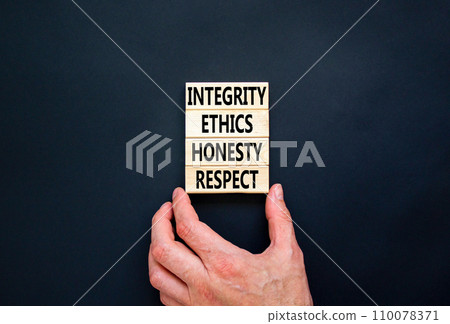 Integrity ethics honesty respect symbol. Concept word Integrity Ethics Honesty Respect on block. Beautiful black background. Businessman hand. Business integrity ethics honesty respect concept. 110078371