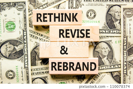 Rethink revise rebrand symbol. Concept word Rethink Revise and Rebrand on block. Dollar bills. Beautiful background from dollar bills. Business brand rethink revise rebrand concept. Copy space. Rethink revise rebrand symbol. Concept word Rethink Revise and Rebrand on block. Dollar bills. Beautiful background from dollar bills. Business brand rethink revise rebrand concept. Copy space. 110078374