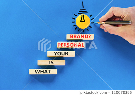 What is your personal brand symbol. Concept words What is your personal brand on wooden blocks. Beautiful blue background. Businessman hand. Business, what is your personal brand concept. Copy space. 110078396
