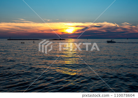 Sunset Over The Mediterranean Sea At The Beach Of The City Porec In Croatia 110078604